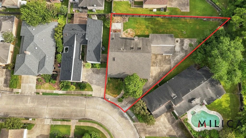 Overhead drone view of a home on a curved street, with an approximate red lot outline and Milica’s branding.